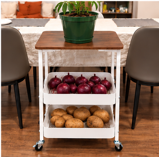 White rolling kitchen cart with wooden top, red onions in middle basket and potatoes in lower basket