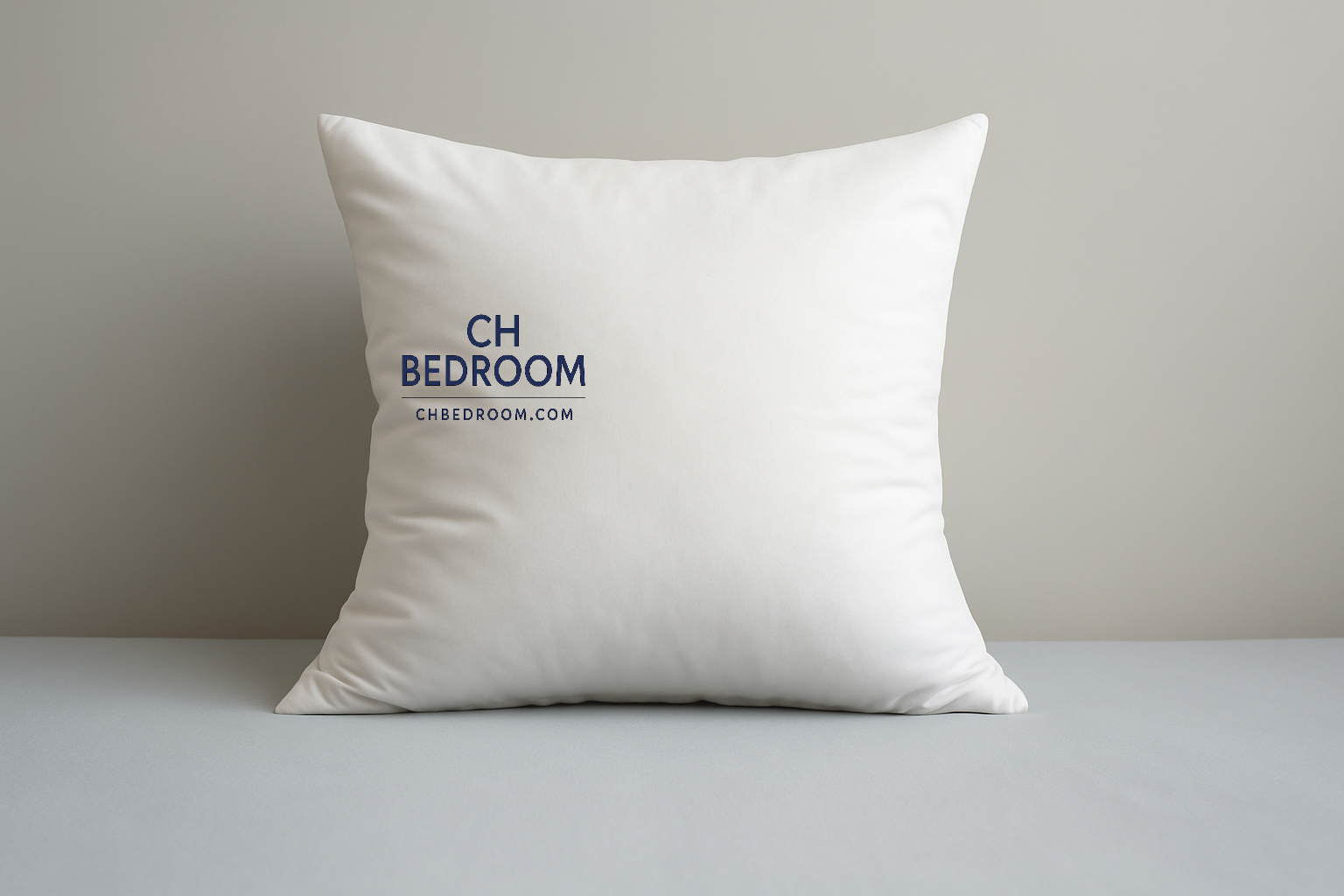 White pillow with 'CH Bedroom' logo on a gray surface and background #canada #canadahome #pillowcanada